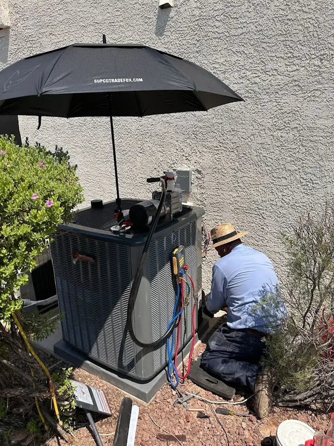 HVAC technician performing outdoor AC maintenance in East Foothills
